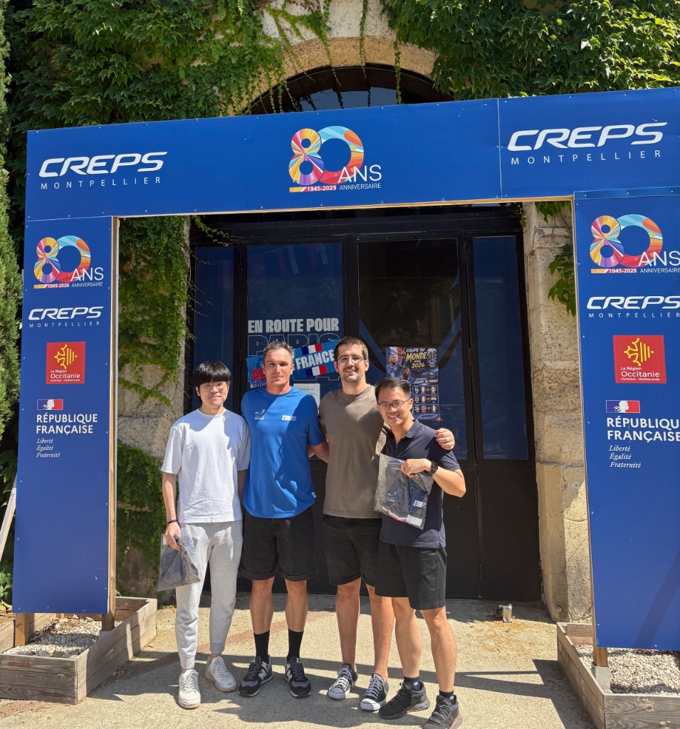 PointFit team with hosts at CREPS Montpellier under the 80th anniversary archway